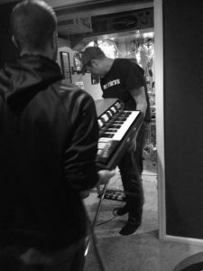 Two men carrying a Fender Contempo Organ